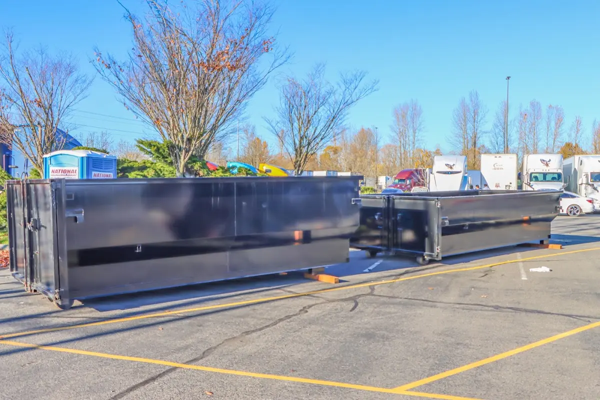 Professional dumpster rental service with roll-off container on residential driveway in La Plata